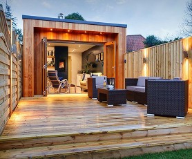 Archived photograph of an outdoor heat-pump installation beside a garden building